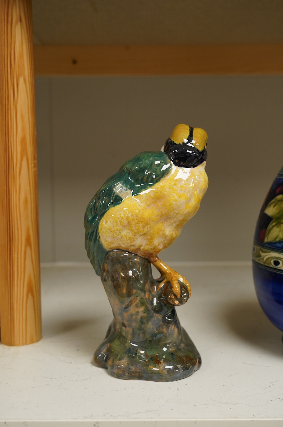 In the manner of Karlsruhe, an Austrian or Italian faience hand painted perching bird, impressed 1532 DO16 etc., 21cm high. Condition - fair to good, minor chips to base